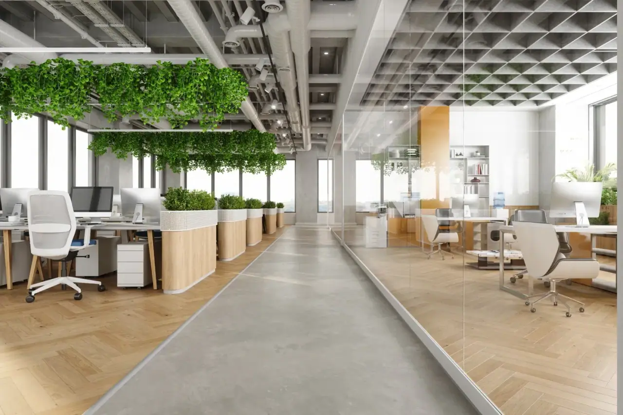 Bright open-plan commercial office with glass partitions and planted workspaces
