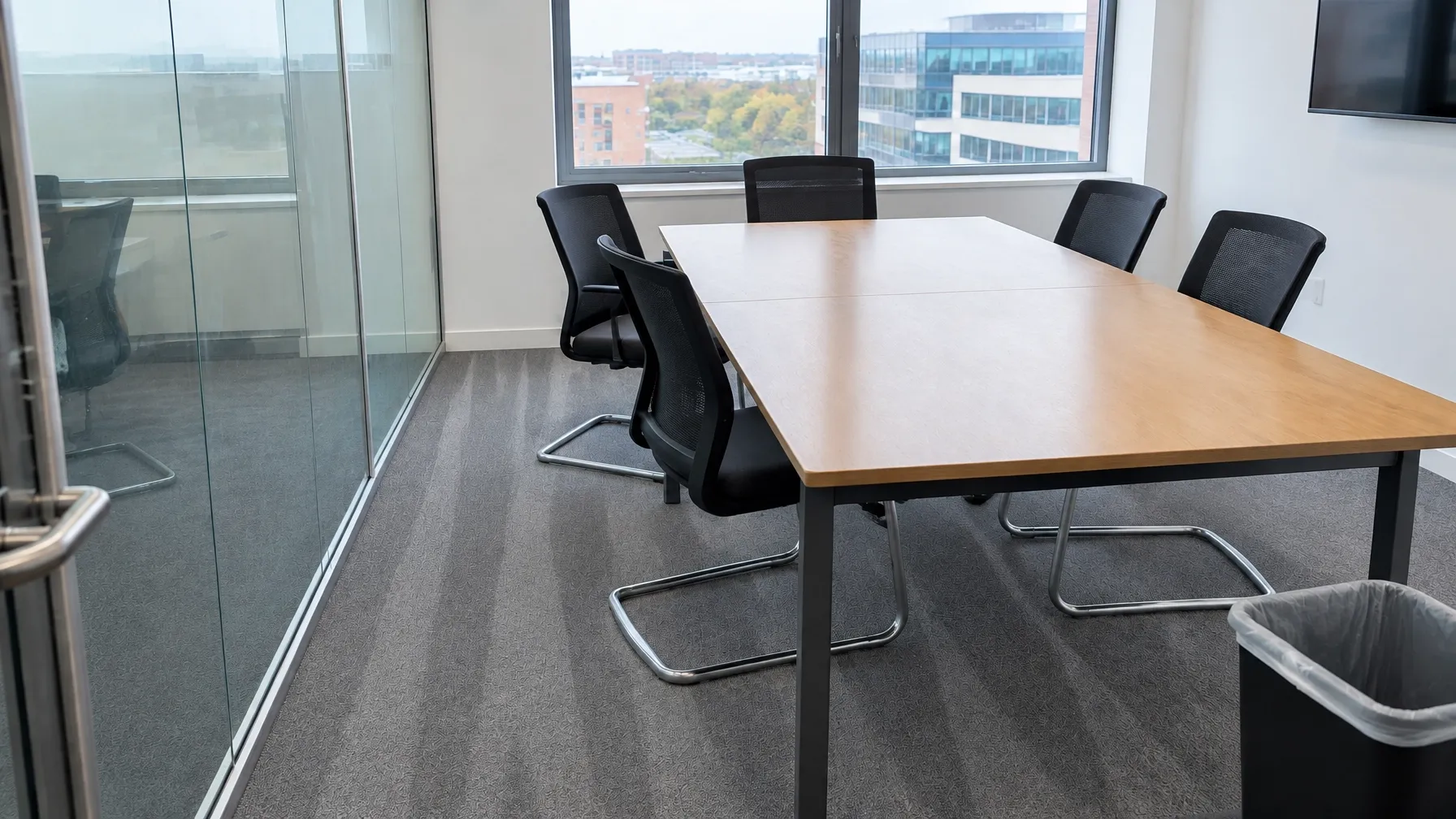 Office meeting room after cleaning, photographed from the matched angle
